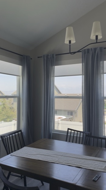 Dining room with shades raised and morning light coming through